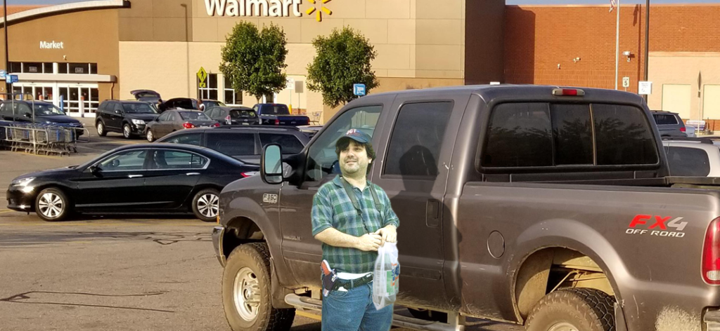 Redneck standing in Walmart parking lot next to pickup with open carry handgun holstered